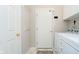 A laundry room features washer, dryer, white cabinets and a back door at 15638 River Birch Rd, Westfield, IN 46074