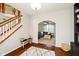 Comfortable living room with archway, hardwood floors, ceiling fan, and staircase at 15638 River Birch Rd, Westfield, IN 46074