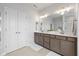 Well-lit bathroom with double vanity, framed mirror, and ample cabinet storage at 17301 Dallington St, Westfield, IN 46074