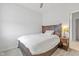 Comfortable bedroom with carpet, a wooden bed frame and a bedside table with a decorative lamp at 17301 Dallington St, Westfield, IN 46074