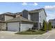 Exterior view of a gray two-story house with an attached garage and manicured lawn at 17301 Dallington St, Westfield, IN 46074