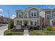Charming two-story home with a covered porch and beautifully landscaped front yard on a sunny day at 17301 Dallington St, Westfield, IN 46074
