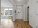 Bright foyer with wood floors, white trim and walls, and a front door with glass and a wreath at 17301 Dallington St, Westfield, IN 46074