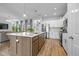 Open-concept kitchen with stainless steel appliances, a center island, and views into the adjacent living spaces at 17301 Dallington St, Westfield, IN 46074