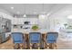 Modern kitchen with a large island, white cabinets, stainless steel appliances, and stylish bar stools at 17301 Dallington St, Westfield, IN 46074