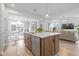 Kitchen island featuring a stainless steel dishwasher and sink, with a view of the dining and living areas at 17301 Dallington St, Westfield, IN 46074