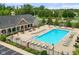 Aerial view of a community pool with lounge chairs, tables, and a clubhouse surrounded by trees at 17301 Dallington St, Westfield, IN 46074