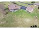 Aerial view of a home, long drive, detached garage, and surrounding green lawn at 195 Hess Rd, Martinsville, IN 46151