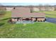 This aerial view shows a lovely brick home with a covered patio and a large lawn at 195 Hess Rd, Martinsville, IN 46151