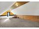 Finished attic features unique ceiling, carpeting, and a rocking chair at 195 Hess Rd, Martinsville, IN 46151