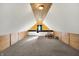 Finished attic showcasing carpeted floors, wood paneling, and a cozy seating area at 195 Hess Rd, Martinsville, IN 46151