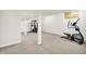 Basement includes exercise equipment on neutral carpet, with white walls and support beams at 195 Hess Rd, Martinsville, IN 46151