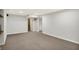 Finished basement with neutral carpet and access to unfinished storage space at 195 Hess Rd, Martinsville, IN 46151