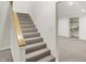 Carpeted basement staircase with wood handrail and finished basement at 195 Hess Rd, Martinsville, IN 46151