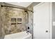 Shower with decorative inset tile shelves next to a white door at 195 Hess Rd, Martinsville, IN 46151