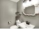 Powder room with a decorative mirror, floating shelves, and modern fixtures at 195 Hess Rd, Martinsville, IN 46151