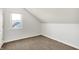 Upstairs bedroom features neutral decor and carpeting with a window at 195 Hess Rd, Martinsville, IN 46151