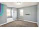 Carpeted bonus room with colorful accent wall, shelving, and windows offers a cozy space at 195 Hess Rd, Martinsville, IN 46151