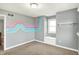 Neutral bedroom featuring a colorful decorative mural and built-in bench under the window at 195 Hess Rd, Martinsville, IN 46151