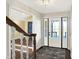 Inviting entryway features a white front door with sidelights and a staircase with wood and white railing at 195 Hess Rd, Martinsville, IN 46151