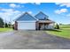Charming exterior view with a blue and brick home, garage, and covered porch at 195 Hess Rd, Martinsville, IN 46151
