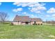 Charming brick home with expansive lawn, pergola-covered patio, and well-maintained landscaping at 195 Hess Rd, Martinsville, IN 46151