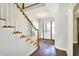 Staircase to upper level with hardwood floors and white railings at 195 Hess Rd, Martinsville, IN 46151