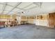 Spacious garage with workbench, shelving, and a door leading to the 'Personal cave' at 195 Hess Rd, Martinsville, IN 46151