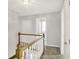 Second floor hallway features wood and white railing with carpeted floor and gray walls at 195 Hess Rd, Martinsville, IN 46151