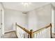 Upstairs hallway featuring a wooden railing and neutral walls at 195 Hess Rd, Martinsville, IN 46151