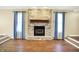 Spacious living room features a stone fireplace and hardwood floors, with windows dressed in blue curtains at 195 Hess Rd, Martinsville, IN 46151