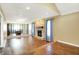 Open-concept living area featuring a stone fireplace, wood floors, and seamless access to the dining room at 195 Hess Rd, Martinsville, IN 46151