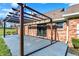 Brick home's patio with pergola, gray pavers and lighting, perfect for outdoor relaxation at 195 Hess Rd, Martinsville, IN 46151