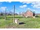 Scenic view of property with unique outdoor decor, lush green grass, and brick home beyond at 195 Hess Rd, Martinsville, IN 46151