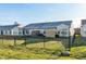 Fenced backyard with a well-maintained lawn, offering a private and secure outdoor space surrounded by neighboring houses at 198 Rapid Rill Ln, Brownsburg, IN 46112