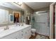 Well-lit bathroom with double sinks and walk-in shower with glass doors at 198 Rapid Rill Ln, Brownsburg, IN 46112