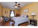 Inviting bedroom with a ceiling fan, dresser, and chair near a window at 198 Rapid Rill Ln, Brownsburg, IN 46112