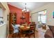Cozy dining area with a round wooden table, cabinet, and decorative chandelier fixture at 198 Rapid Rill Ln, Brownsburg, IN 46112