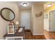 Inviting entryway featuring warm lighting, a decorative mirror, and hardwood floors at 198 Rapid Rill Ln, Brownsburg, IN 46112