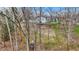 A hillside backyard with a deck and stairs to the river, surrounded by trees at 207 E Ohio St, Mooresville, IN 46158
