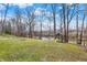 Large backyard offers a playset, mature trees, grassy areas, and water access at 207 E Ohio St, Mooresville, IN 46158