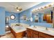Bright blue bathroom featuring a jacuzzi tub and double sinks at 207 E Ohio St, Mooresville, IN 46158