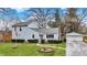 Charming two-story home with well-maintained lawn, complemented by a detached two car garage and mature trees at 207 E Ohio St, Mooresville, IN 46158