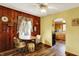 Kitchen nook with wood paneling, natural light and wood-look floors flowing into the adjacent kitchen area at 207 E Ohio St, Mooresville, IN 46158