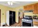 Well-lit kitchen featuring black and stainless steel appliances, modern flooring, and ample natural light at 207 E Ohio St, Mooresville, IN 46158