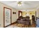 Spacious living room with wood-look floors, ceiling fan, and seamless flow into additional living spaces at 207 E Ohio St, Mooresville, IN 46158