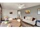 Cozy living space with neutral tones, modern ceiling fan, and wood-look floors at 207 E Ohio St, Mooresville, IN 46158