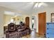 Spacious living room with wood-look floors, ceiling fan, and seamless flow into additional living spaces at 207 E Ohio St, Mooresville, IN 46158