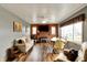 Inviting living room features wood paneling, brick fireplace, wood floors and an abundance of natural light at 207 E Ohio St, Mooresville, IN 46158