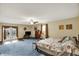 Spacious main bedroom with a ceiling fan, exterior access, and large carpeted floor at 207 E Ohio St, Mooresville, IN 46158